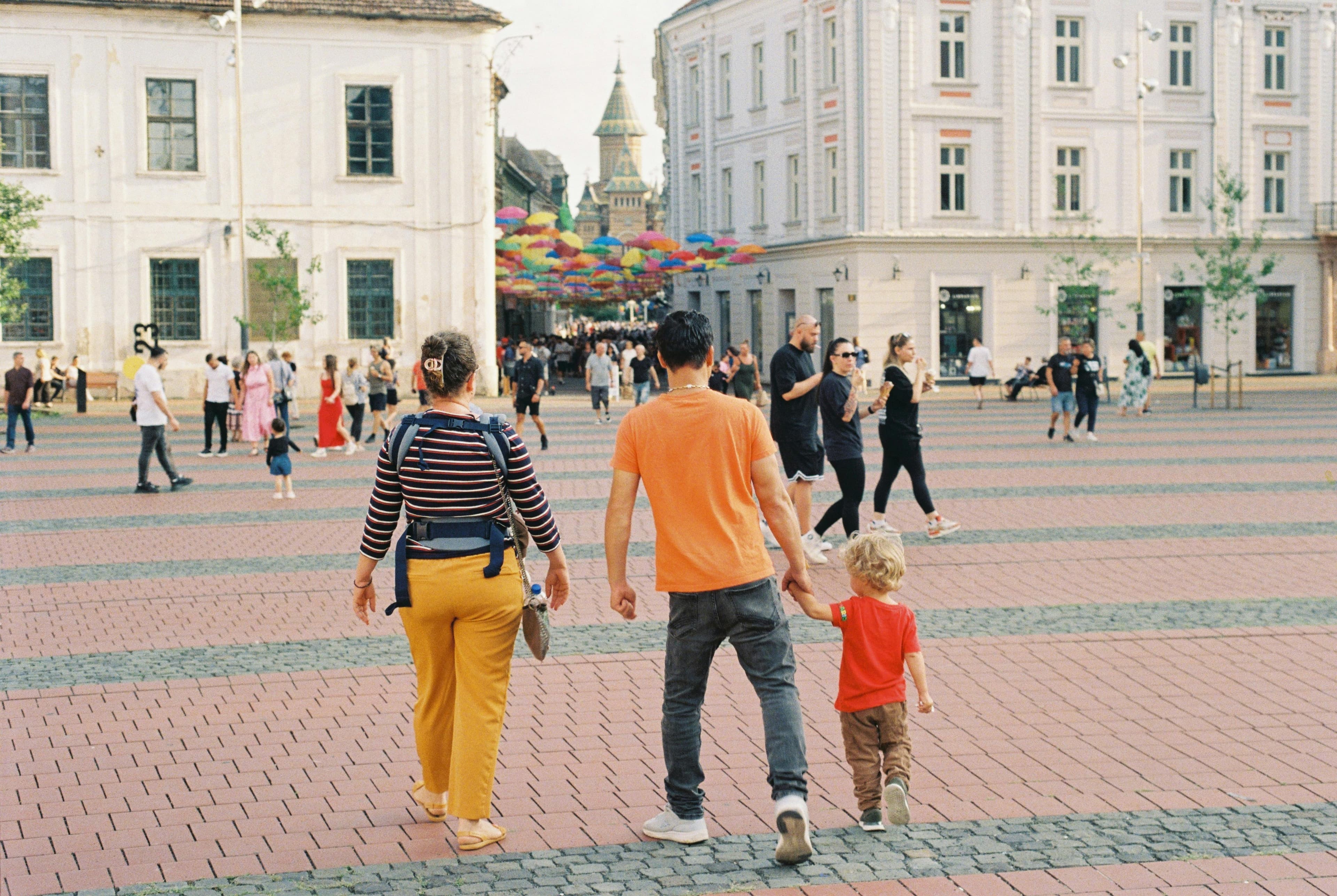 Family gathered together in a living room using a tablet